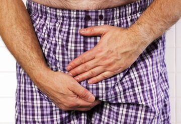 man holding his crotch
